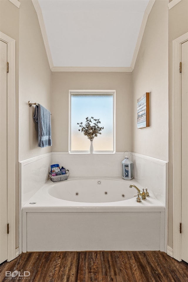 bathroom featuring ornamental molding, hardwood / wood-style floors, and a bathtub