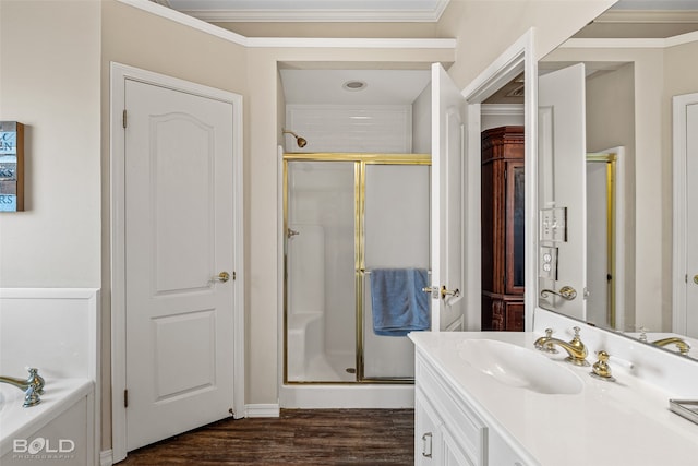 bathroom with plus walk in shower, wood-type flooring, vanity, and crown molding