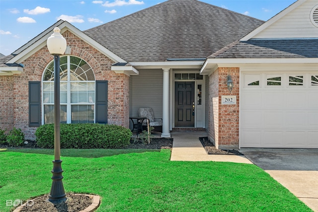 view of front facade with a front yard and a garage