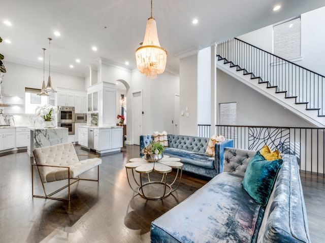 living room with ornamental molding, dark hardwood / wood-style flooring, and a notable chandelier