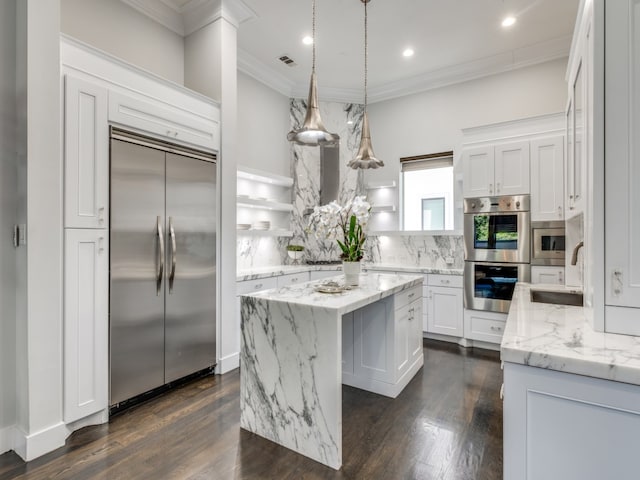 kitchen featuring dark wood-type flooring, white cabinets, a kitchen island, built in appliances, and sink