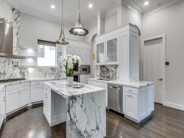 kitchen featuring a center island, stainless steel appliances, and white cabinets