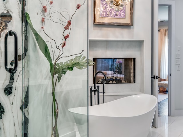 bathroom with sink, tile patterned flooring, and a bath