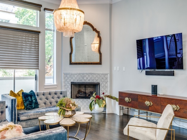 living room featuring crown molding, dark wood-type flooring, and a wealth of natural light