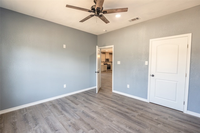 unfurnished bedroom featuring ceiling fan and light hardwood / wood-style flooring