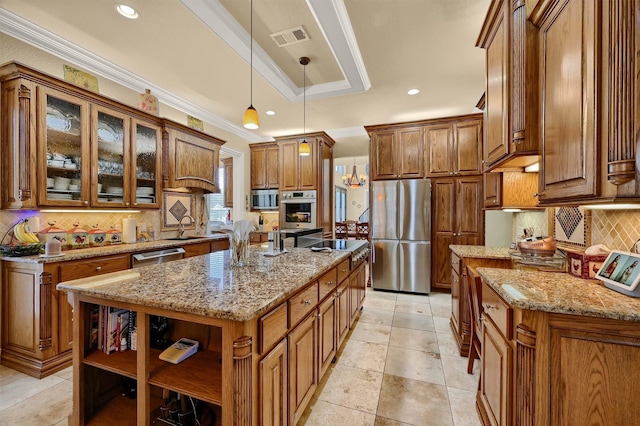 kitchen with stainless steel appliances, a center island with sink, decorative light fixtures, crown molding, and light stone countertops