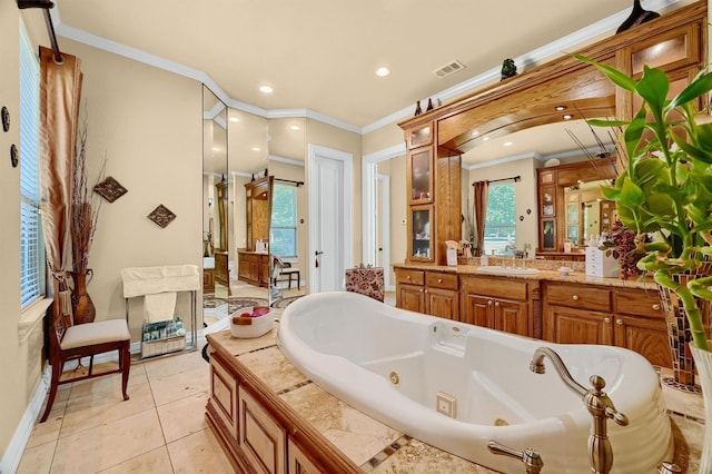 bathroom featuring a tub to relax in, crown molding, tile patterned flooring, and vanity