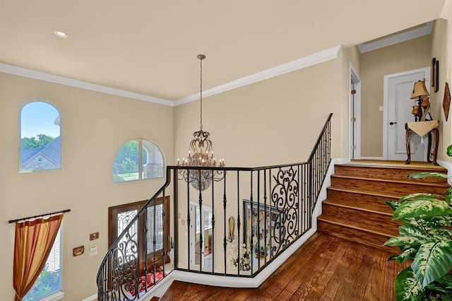 interior space with ornamental molding, hardwood / wood-style flooring, and a chandelier