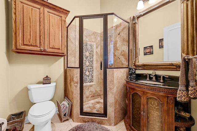 bathroom featuring vanity, tile patterned floors, an enclosed shower, and toilet