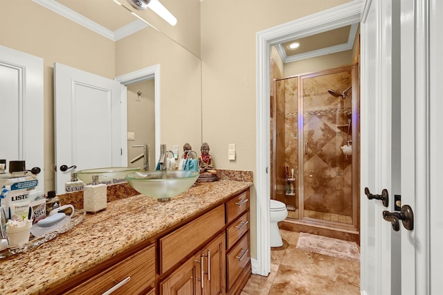 bathroom with ornamental molding, vanity, a shower with shower door, and toilet