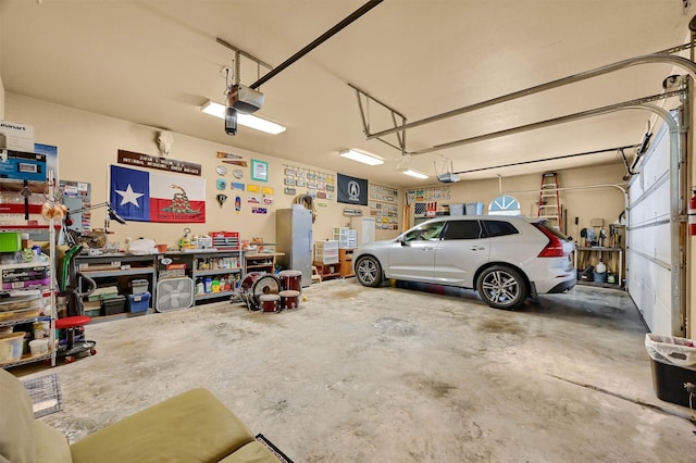 garage featuring a garage door opener and a workshop area