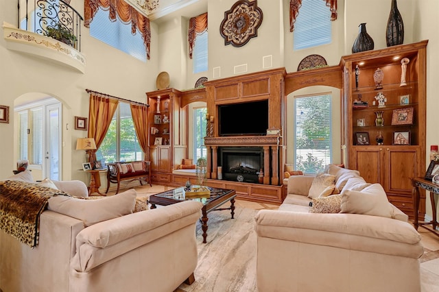 tiled living room with a towering ceiling and ornamental molding