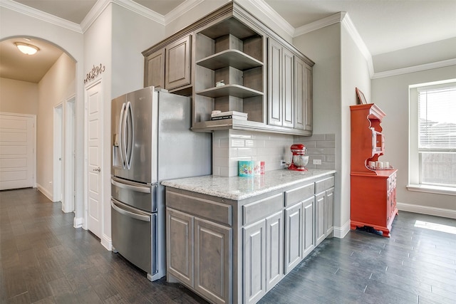 kitchen with crown molding, backsplash, dark hardwood / wood-style floors, and stainless steel fridge with ice dispenser