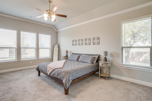 carpeted bedroom featuring ceiling fan, crown molding, vaulted ceiling, and multiple windows