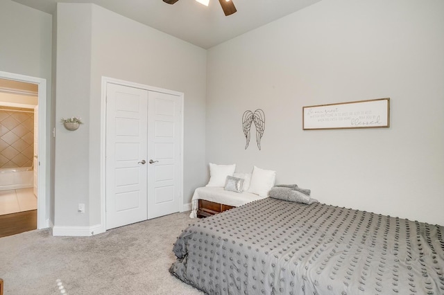 carpeted bedroom with ceiling fan and a closet