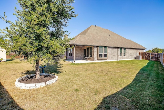 back of property featuring cooling unit, a lawn, and a patio