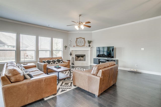 living room featuring ceiling fan, crown molding, a fireplace, and dark hardwood / wood-style flooring