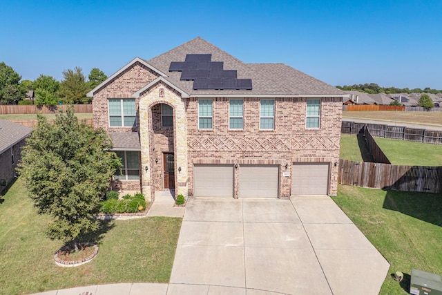 view of front of property with a front yard and a garage