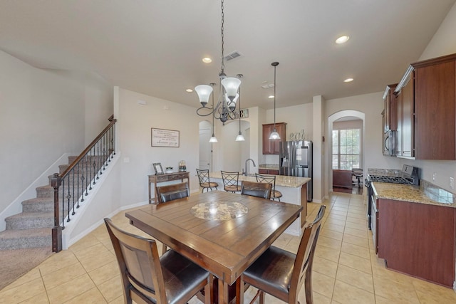 dining room featuring light tile patterned floors and an inviting chandelier