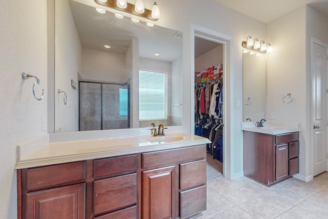 bathroom featuring vanity, walk in shower, and tile patterned floors