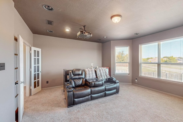 home theater with light carpet and a textured ceiling