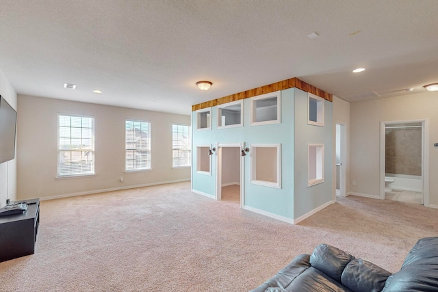 carpeted living room featuring a textured ceiling