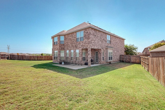 rear view of house with a yard and a patio