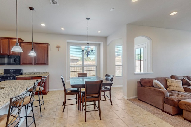 dining room with light tile patterned flooring and an inviting chandelier