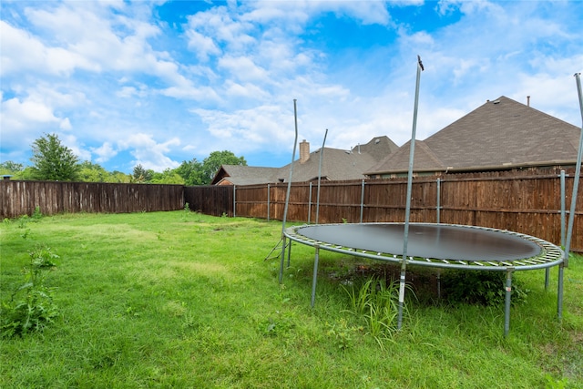 view of yard with a trampoline