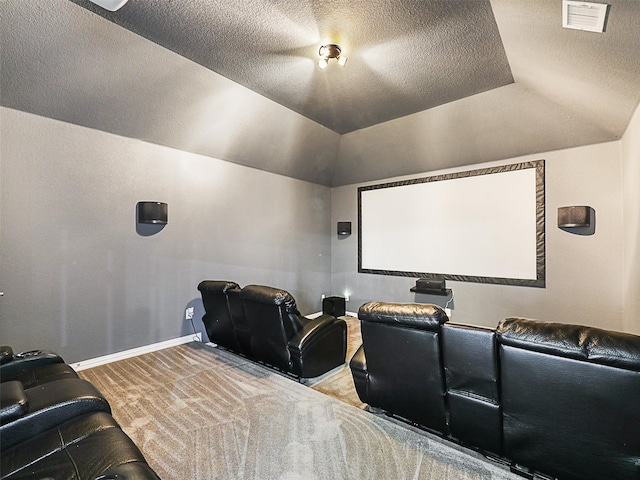 home theater featuring a textured ceiling and carpet