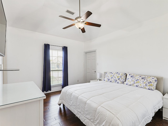 bedroom with ceiling fan and dark wood-type flooring