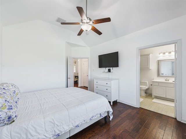 bedroom with vaulted ceiling, dark hardwood / wood-style flooring, ceiling fan, and ensuite bathroom