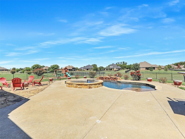 view of pool with a playground and a patio area