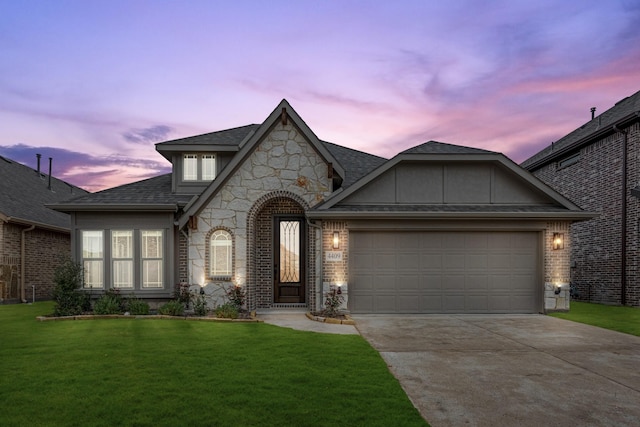 view of front of house with a garage and a yard