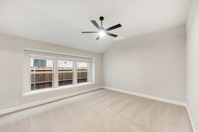 carpeted empty room with ceiling fan and lofted ceiling