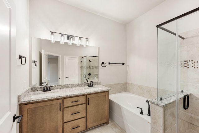 bathroom featuring plus walk in shower, vanity, and tile patterned floors