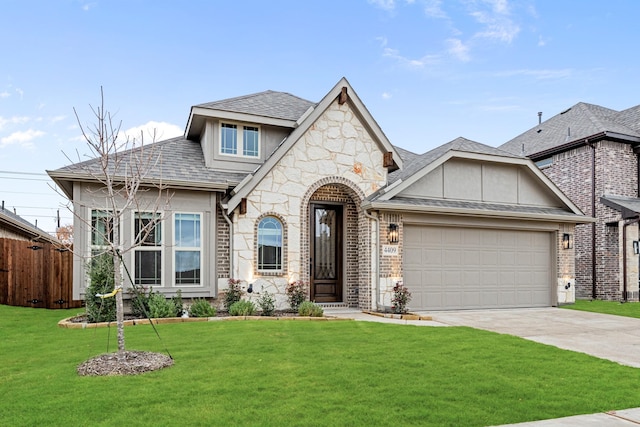 view of front of property with a garage and a front lawn