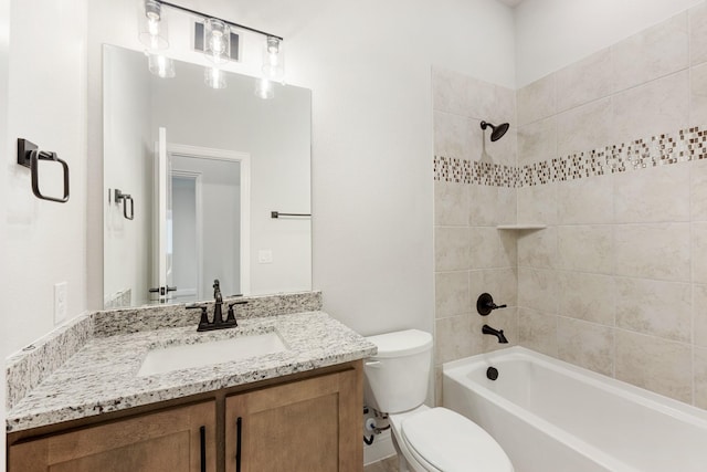 full bathroom featuring vanity, toilet, and tiled shower / bath combo