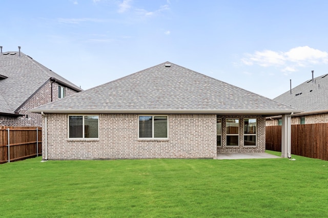 back of house with a yard and a patio