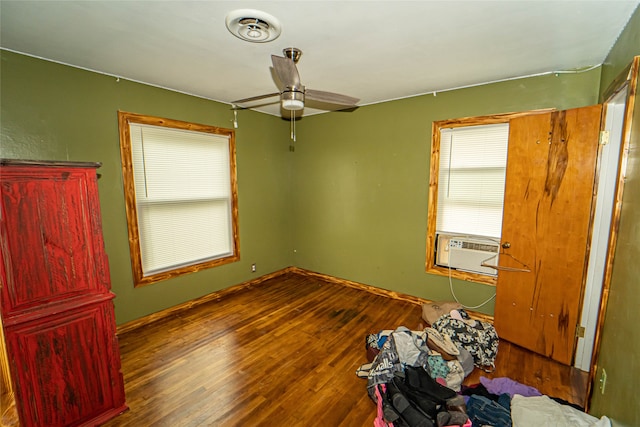 unfurnished room featuring cooling unit, ceiling fan, and hardwood / wood-style flooring