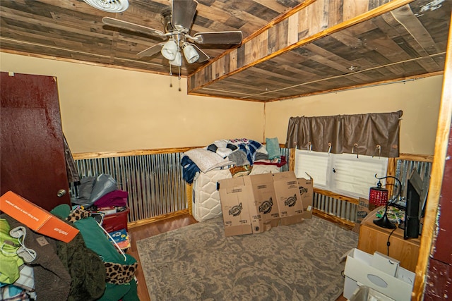 carpeted bedroom featuring ceiling fan and wood ceiling