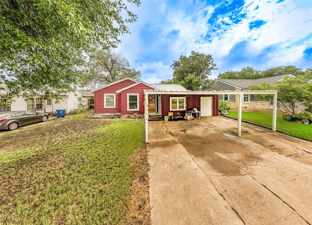 ranch-style house with a garage, a carport, and a front lawn