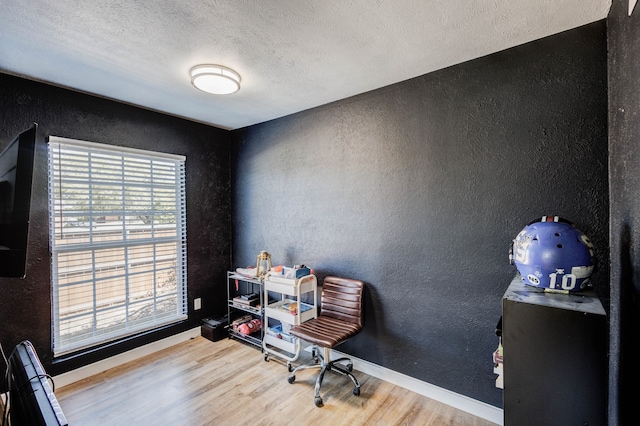 office with hardwood / wood-style flooring and a textured ceiling