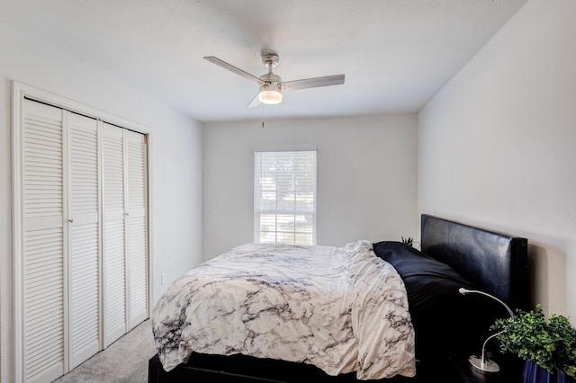 carpeted bedroom featuring ceiling fan and a closet