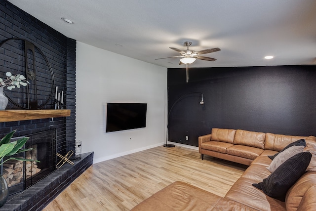 living room featuring a fireplace, ceiling fan, and hardwood / wood-style flooring