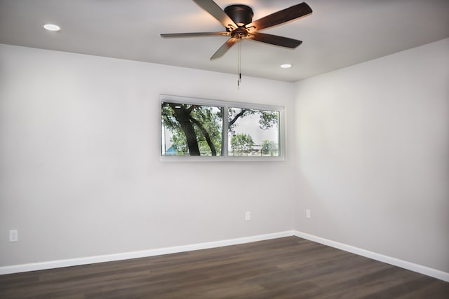 unfurnished room featuring dark wood-type flooring and ceiling fan