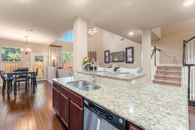 kitchen with dishwasher, sink, hanging light fixtures, dark hardwood / wood-style floors, and light stone counters