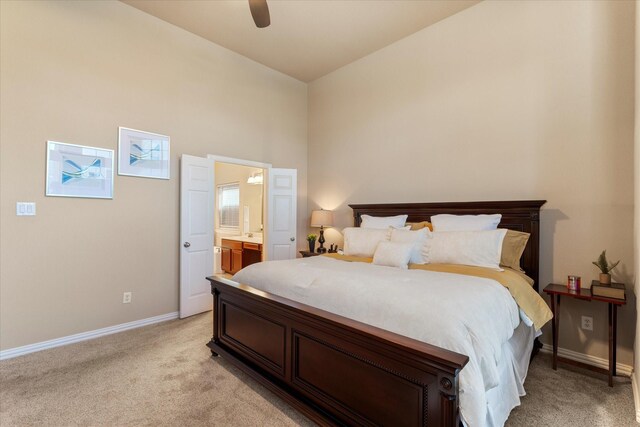 carpeted bedroom featuring ceiling fan, connected bathroom, and vaulted ceiling