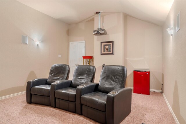 home theater room featuring carpet floors and lofted ceiling