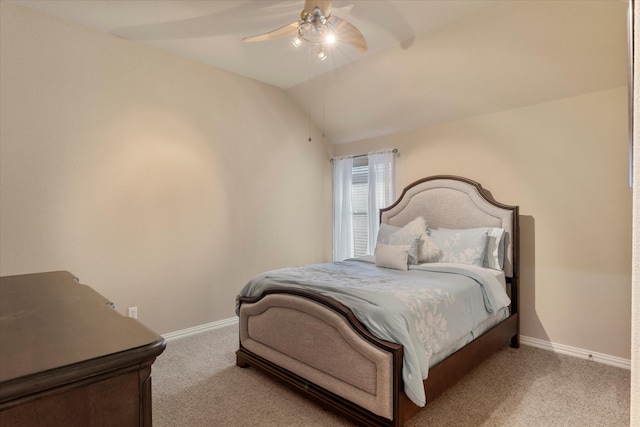 bedroom featuring light colored carpet, vaulted ceiling, and ceiling fan